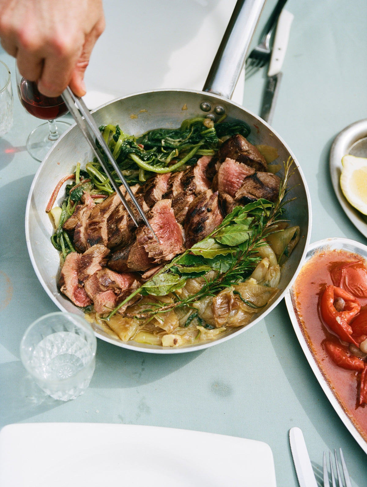 Wild boar tenderloin with baked onions and young chard, served from the pan